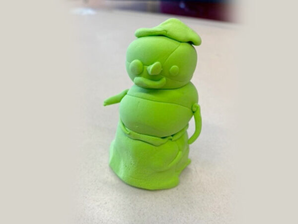 Small figure made from green clay.