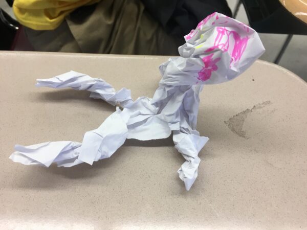 A bird made out of a piece of crumpled white paper.